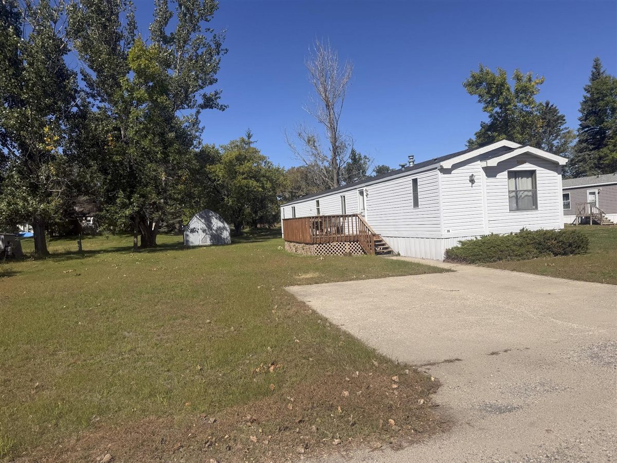 A white home with a wooden deck at Kountry Manor